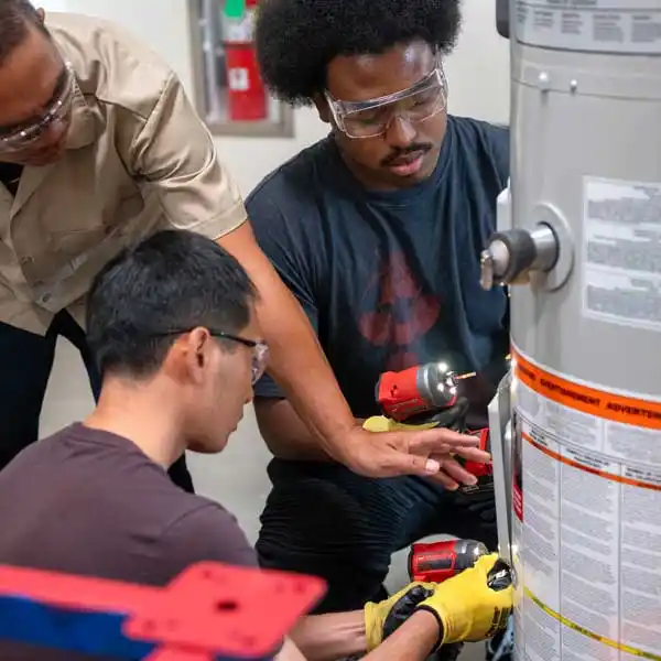 Students working on HVAC unit