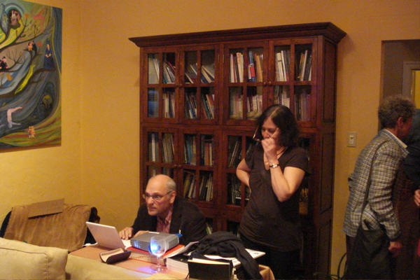 Bernstein and Bee consult on fine points of power point presentation. Top left corner: bottom right corner of one of Bee's paintings.