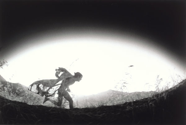 Eikoh Hosoe, Kamaitachi #31 [Caped Kamaitachi running through field], 1968, printed 1971; Promised gift of Paul Sack to the Sack Photographic Trust 