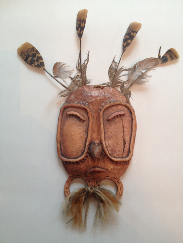 Jeanne Johnson (1950 - 2016). Yup'ik Mask; clay, feather, fingerprints, yarn.