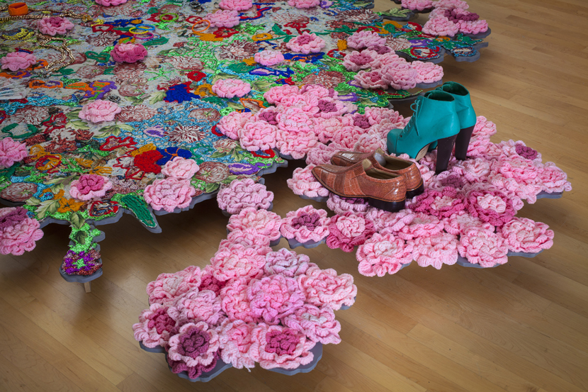 Ebony G. Patterson, Where We Found Them, 2014; mixed media jacquard weaved tapestry with jewelry, shoes, gold chains, tassels, 100 crochet flowers, 8ft x 6ft; installation view of Dead Treez, installation view, John Michael Kohler Arts Center in Sheboygan, Wisconsin; courtesy Monique Meloche Gallery Ebony G. Patterson, Where We Found Them, 2014; mixed media jacquard weaved tapestry with jewelry, shoes, gold chains, tassels, 100 crochet flowers, 8ft x 6ft; installation view of Dead Treez, installation view, John Michael Kohler Arts Center in Sheboygan, Wisconsin; courtesy Monique Meloche Gallery