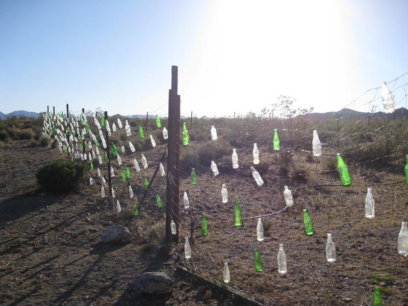 Bottle + fence construction used to produce sounds for Rhyolite (2016).
