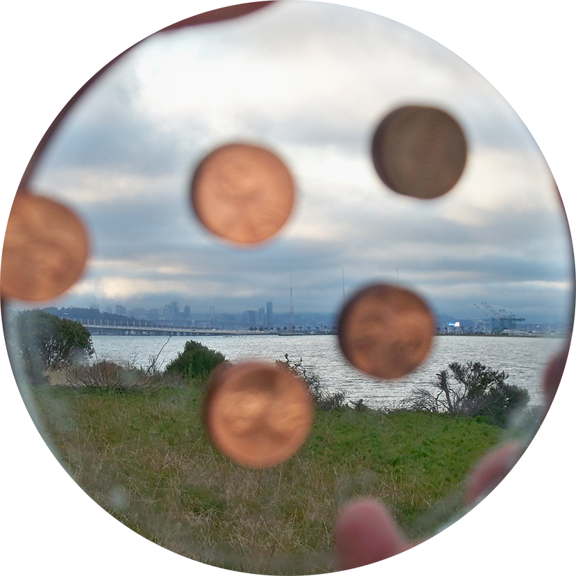 Emblem for Emeryville Mudflats; pennies, mirror. Emblem for Emeryville Mudflats; pennies, mirror.