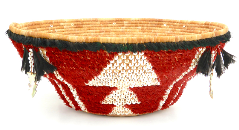 Commissioned by the Oakland Museum of California, this ceremonial feathered basket is now featured in their Gallery of California History. It contains more than 19,000 stitches, nearly 200 willow sticks, and 1200 handmade shell beads. If placed end-to-end, the weaving strands would stretch the length of four football fields. Photo by Linda Yamane. Commissioned by the Oakland Museum of California, this ceremonial feathered basket is now featured in their Gallery of California History. It contains more than 19,000 stitches, nearly 200 willow sticks, and 1200 handmade shell beads. If placed end-to-end, the weaving strands would stretch the length of four football fields. Photo by Linda Yamane.