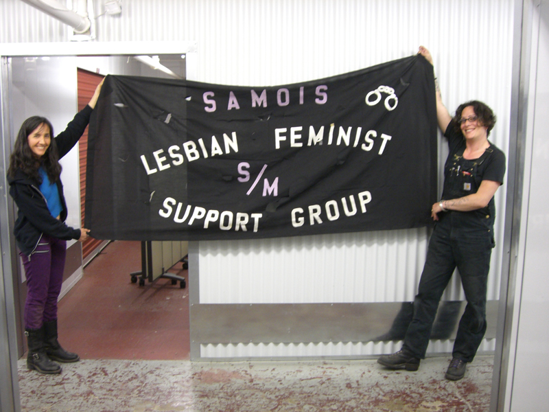 Dorian and board member Marlene Hoeber with banner from Patrick Califia collection.