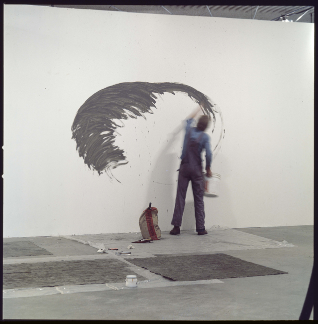 David Ireland making wall work for the exhibition 18 Bay Area Artists, Los Angeles institute of Contemporary Art, 1976; image courtesy of The 500 Capp Street Foundation.