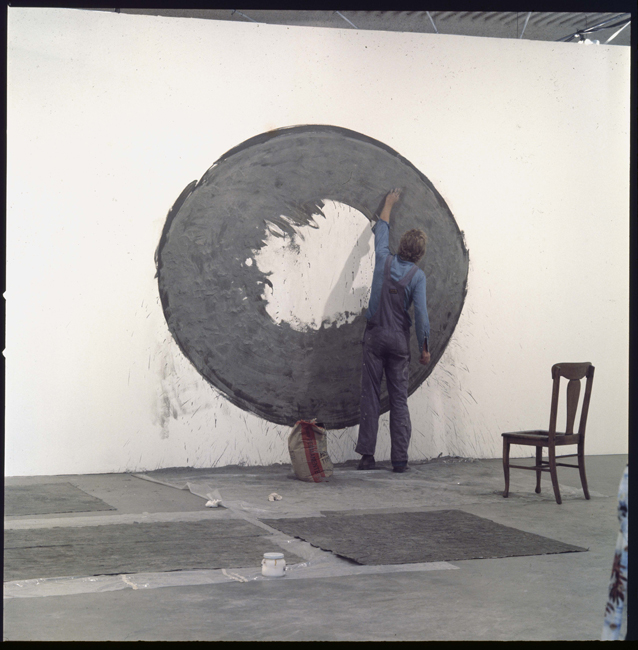 David Ireland making wall work for the exhibition 18 Bay Area Artists, Los Angeles institute of Contemporary Art, 1976; image courtesy of The 500 Capp Street Foundation.