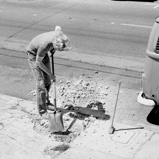 David Ireland repairing the sidewalk, 500 Capp Street, 1976; photo: Tom Marioni; image courtesy of The 500 Capp Street Foundation.