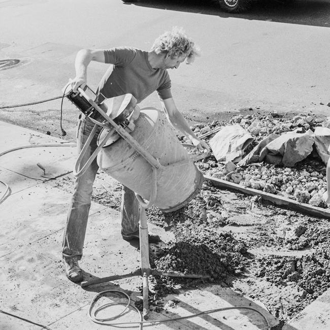 David Ireland repairing the sidewalk, 500 Capp Street, 1976; photo: Tom Marioni; image courtesy of The 500 Capp Street Foundation.