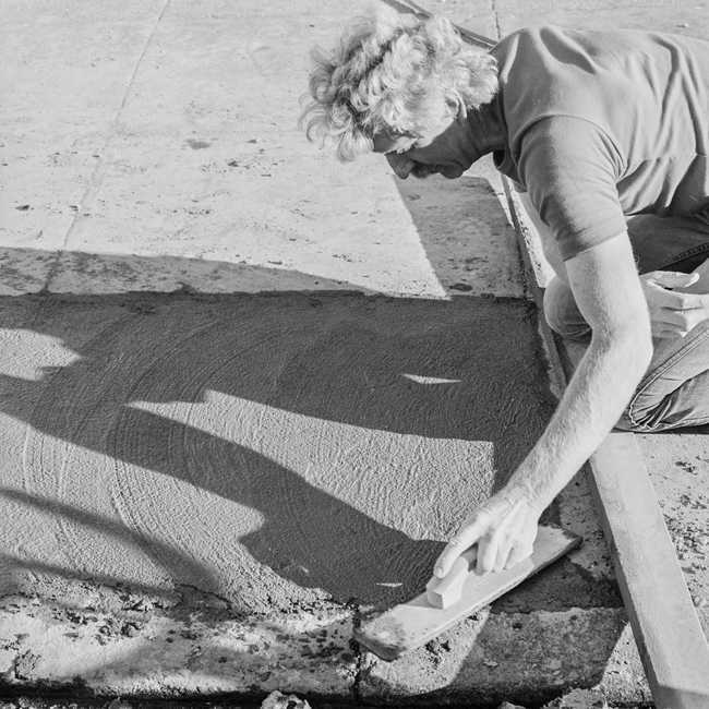 David Ireland repairing the sidewalk, 500 Capp Street, 1976; photo: Tom Marioni; image courtesy of The 500 Capp Street Foundation.