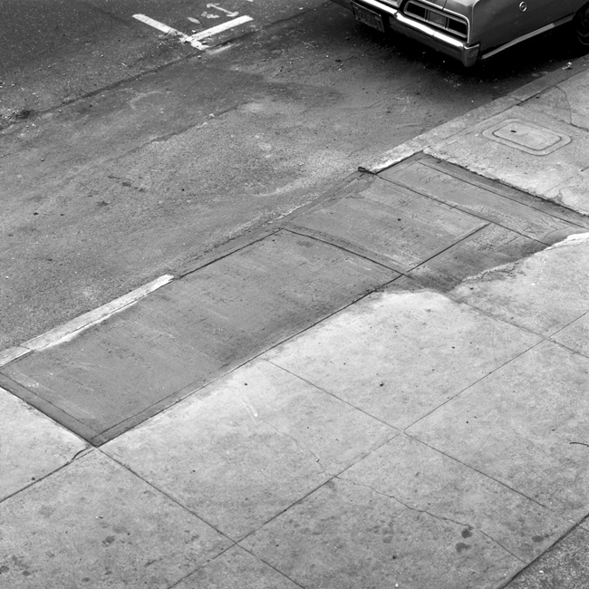 David Ireland repairing the sidewalk, 500 Capp Street, 1976; photo: Tom Marioni; image courtesy of The 500 Capp Street Foundation.