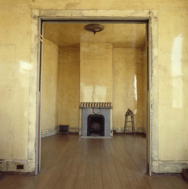 Second level back parlor with jars of sand on the mantel and Elephant Stool (1978), 1978; photo: David Ireland; image courtesy of The 500 Capp Street Foundation.