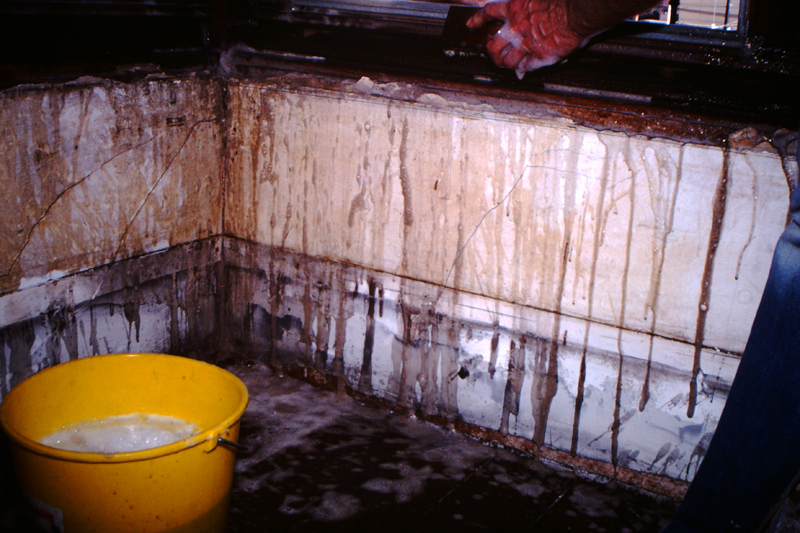David Ireland cleaning the window trim in the front parlor room at 500 Capp Street, c.1976; photo: Steven Kayfetz; image courtesy of The 500 Capp Street Foundation.