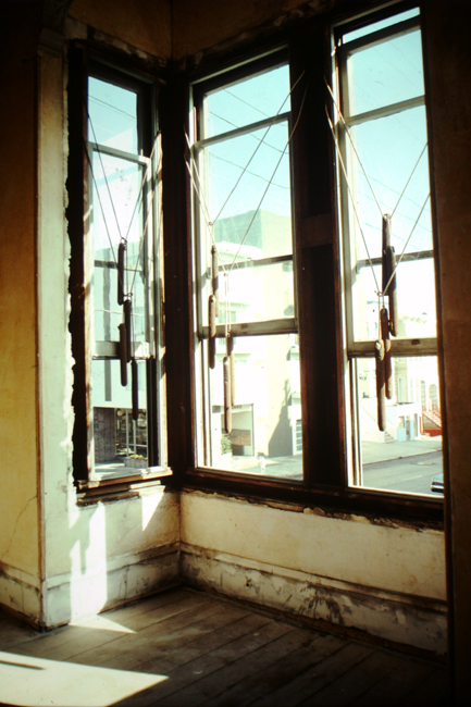 Front parlor room windows with trim removed and arrangement of weights, 1977; photo: David Ireland; image courtesy of The 500 Capp Street Foundation.