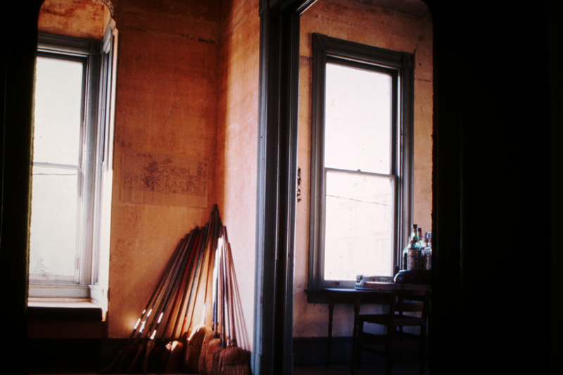 Brooms found in every corner of every room inside 500 Capp Street, leaning against the back parlor room wall, c.1976; photo: David Ireland; image courtesy of The 500 Capp Street Foundation.