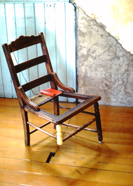 David Ireland, Three-Legged Chair, 1978; wood chair, journal, and metal chain; 30 ½ x 18 x 17 inches; photo: Abe Frajndlich; image courtesy of The 500 Capp Street Foundation.