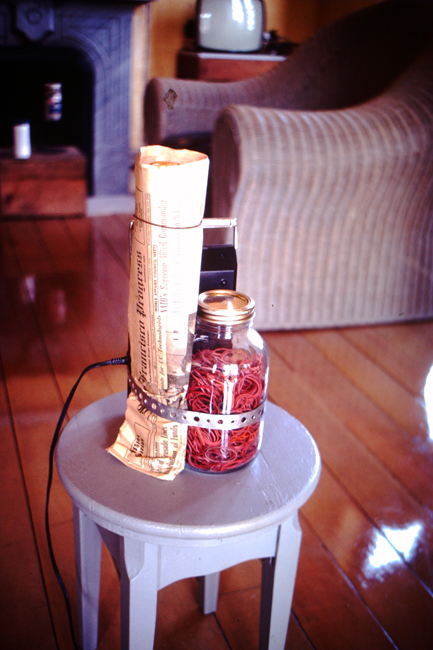 Tape recorder, newspaper, jar with rubber bands on wooden stool, c. 1977; photo: David Ireland; image courtesy of The 500 Capp Street Foundation.