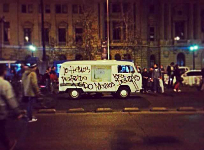 The van that held the ash remains of student debt promissory notes in Ad augusta per angusta painted with the words “We have lost everything except our debts.”