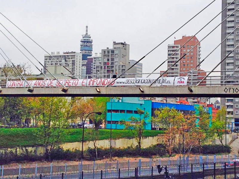 Banner hanging from a bridge in Santiago, Chile directs passers-by to the Popular Declassification website — “Against 50 years of secrecy and impunity.”