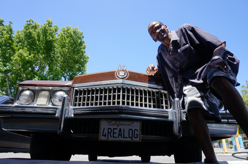 Diamond Jim in front of his ride with customized license plates. Photo credit: Pendarvis Harshaw.