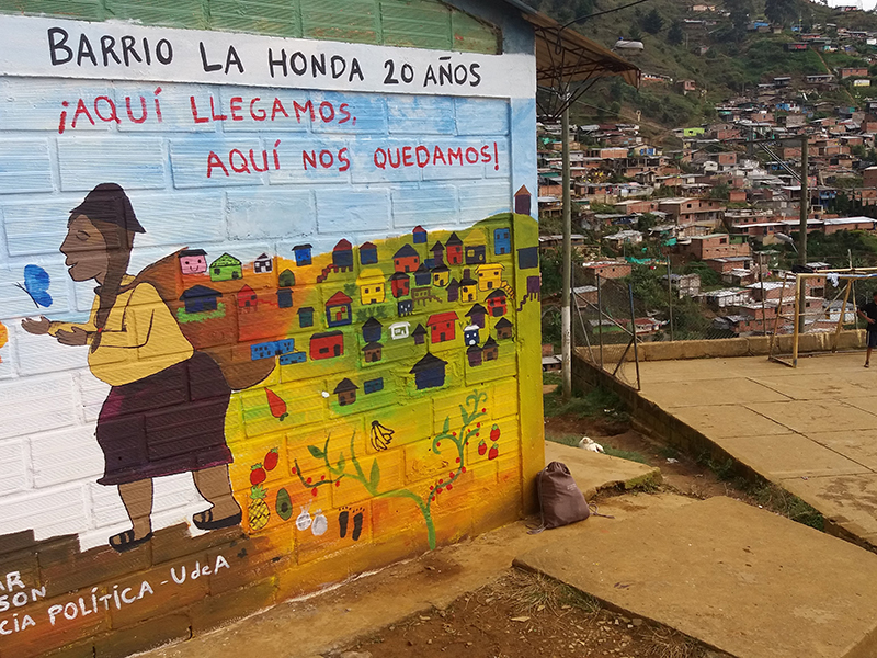 A mural painted by community members in the La Honda neighborhood in Medellín. The neighborhood is primarily composed of families displaced from rural areas in the state of Antioquia. The inhabitants are being forced to resist again in order to avoid being displaced (again) by the state. Photo credits: James Granada, Master of political science, Universidad de Antioquia.