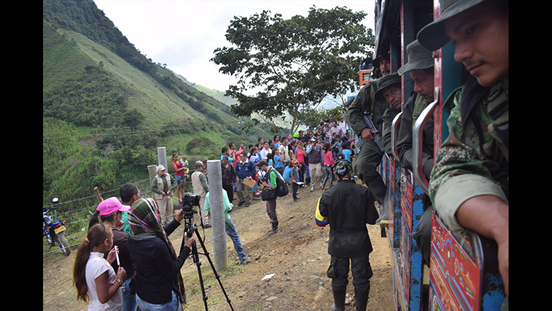 Ex-FARC members in a chiva (local bus) on their way to the vereda Santa Lucía, where they were about to give up their weapons and uniforms before entering the ETCR Román Ruiz. Photo credit: Communications team of the ETCR Román Ruiz.