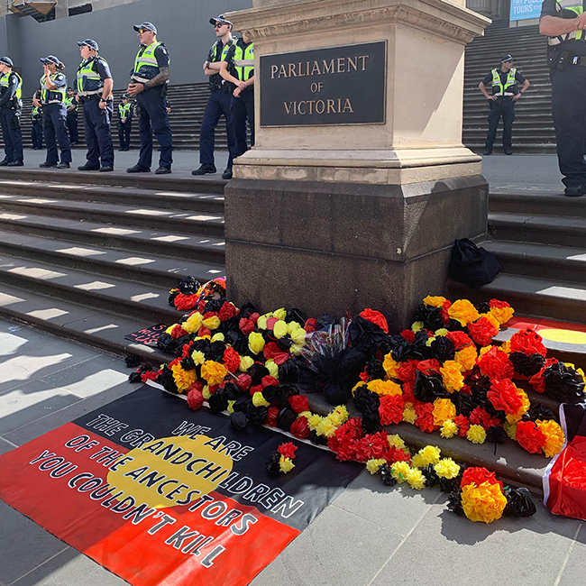 A tribute on the steps of Parliament House, surrounded by cops, January 26 2019.