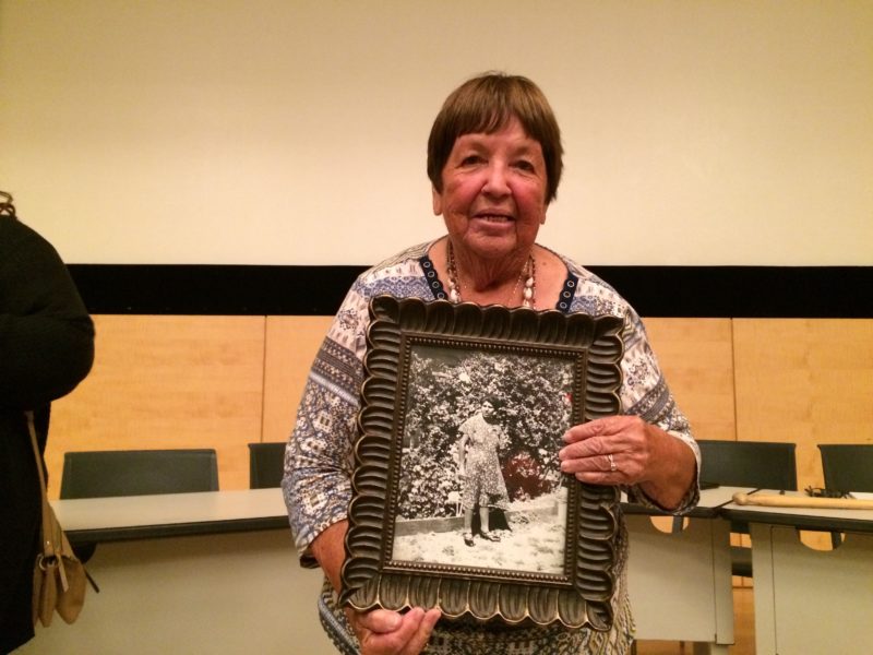 Ruth Orta holding a framed photograph of her mother, after the panel.