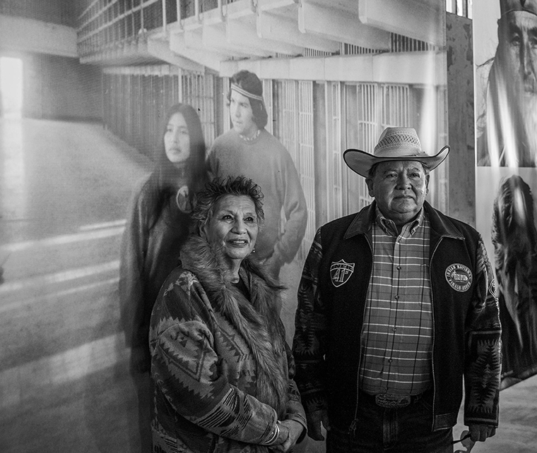 Alcatraz veterans stand in front of their portrait fifty years later. Photo: Joey Montoya.