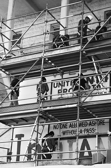 Indigenous youth, elders, and families restore political artwork painted fifty years ago on Alcatraz in 1969, as part of the November 20, 2019 commemorations. Photo: Joey Montoya.