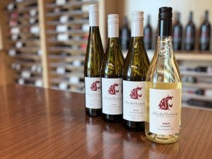 four bottles of white wine on a table