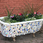 Pottery shards adhered to an upcycled bathtub