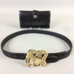 Gucci Black Leather Wallet and Leather Belt with Sterling Silver Ram Buckle, buckle with gem-set eyes, (imperfections). (Lot 2303, Estimate: $60-80)