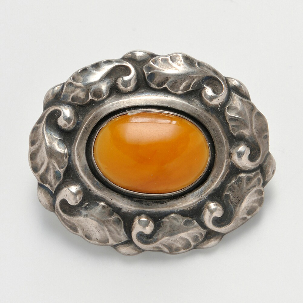 Georg Jensen Brooch with an oval yellow amber at the center