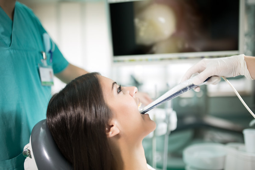 Dental office-specialist tools,intro oral dental camera with live picture of teeth on the monitor.Dental care,dental hygiene,check up.Dentist examines teeth of the patient.Plaque and caries prevention