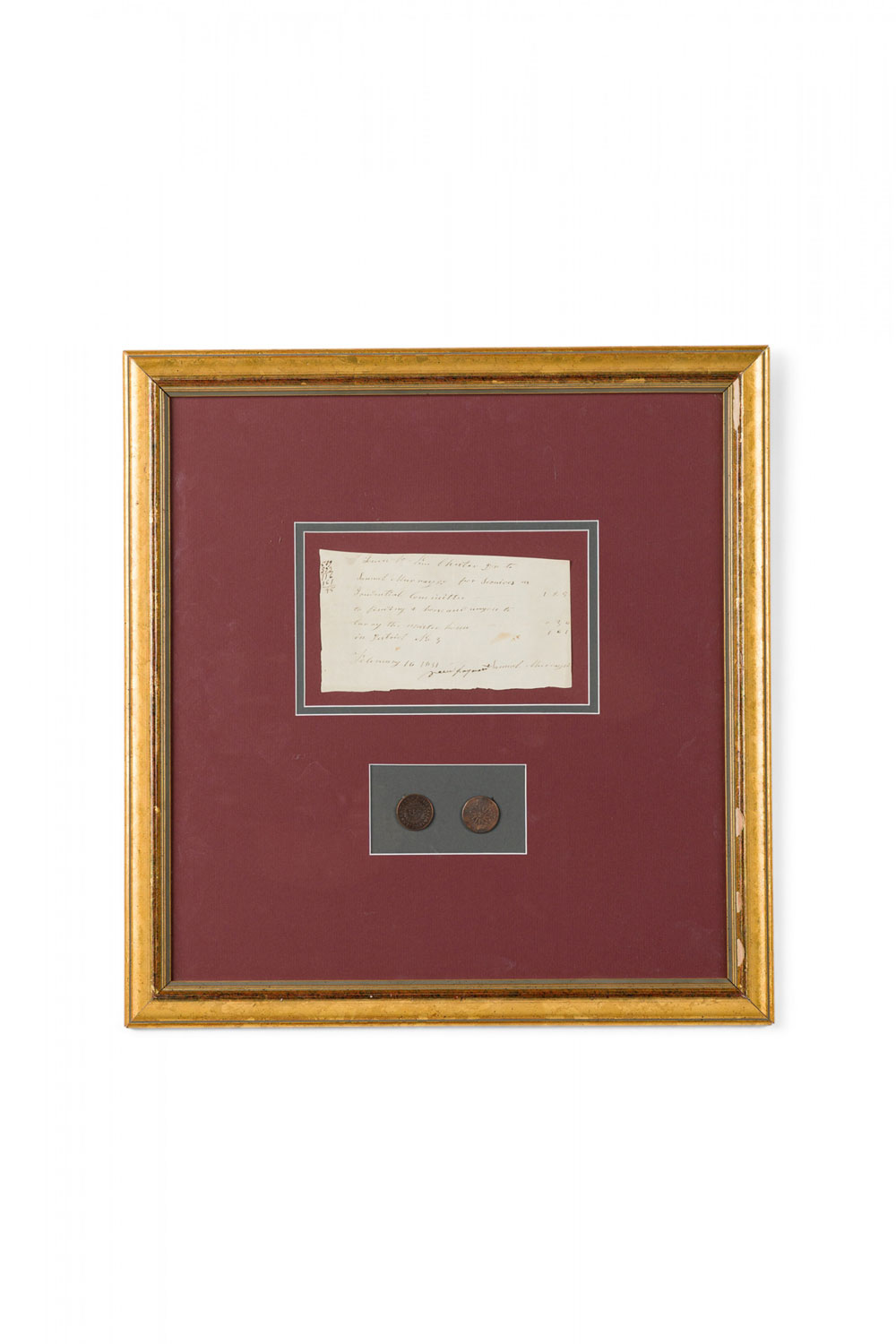 Letter fragment and antique coins in burgundy matting and a gilt frame