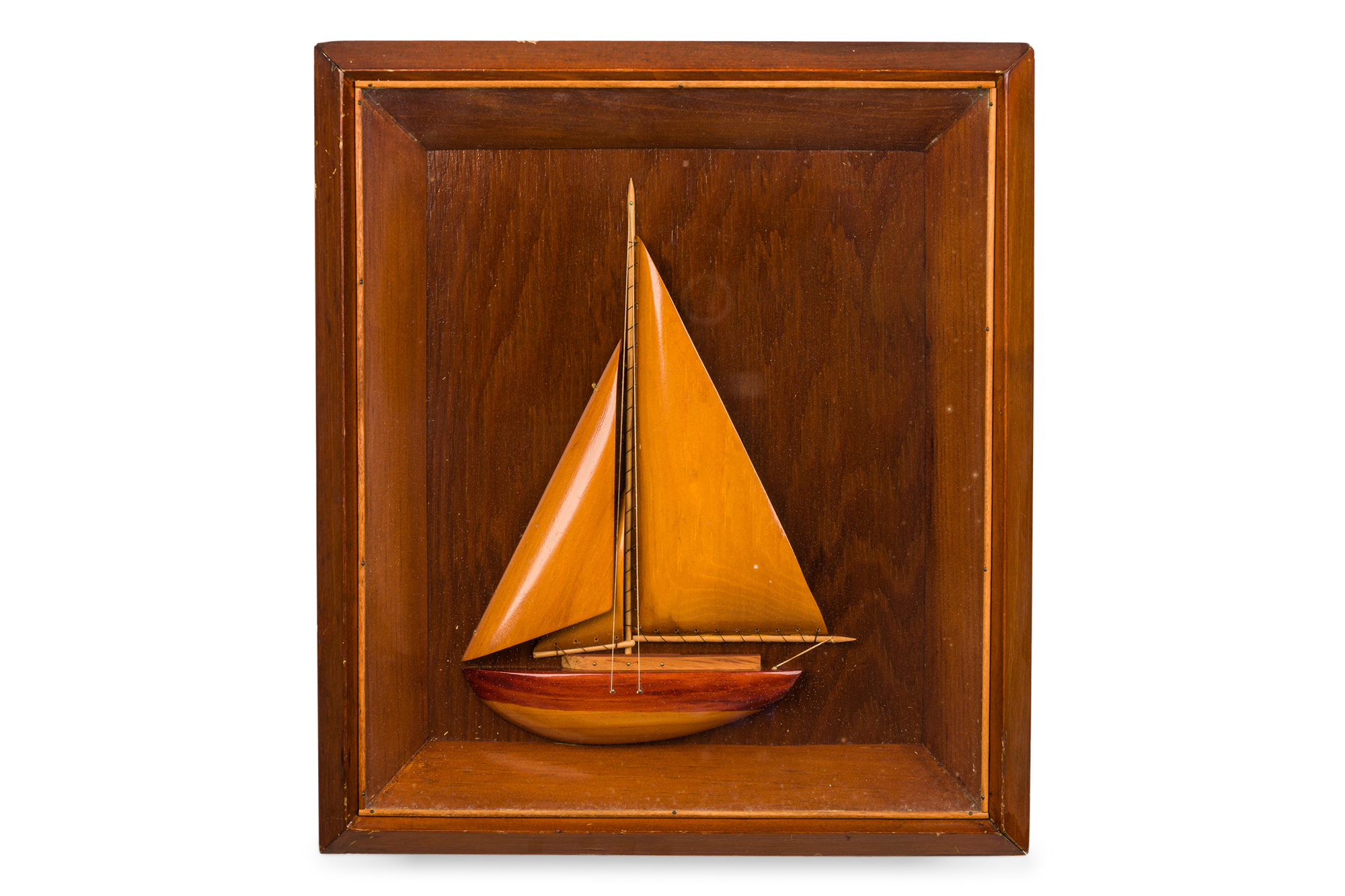 Vintage carved wooden sailboat in a shadow box