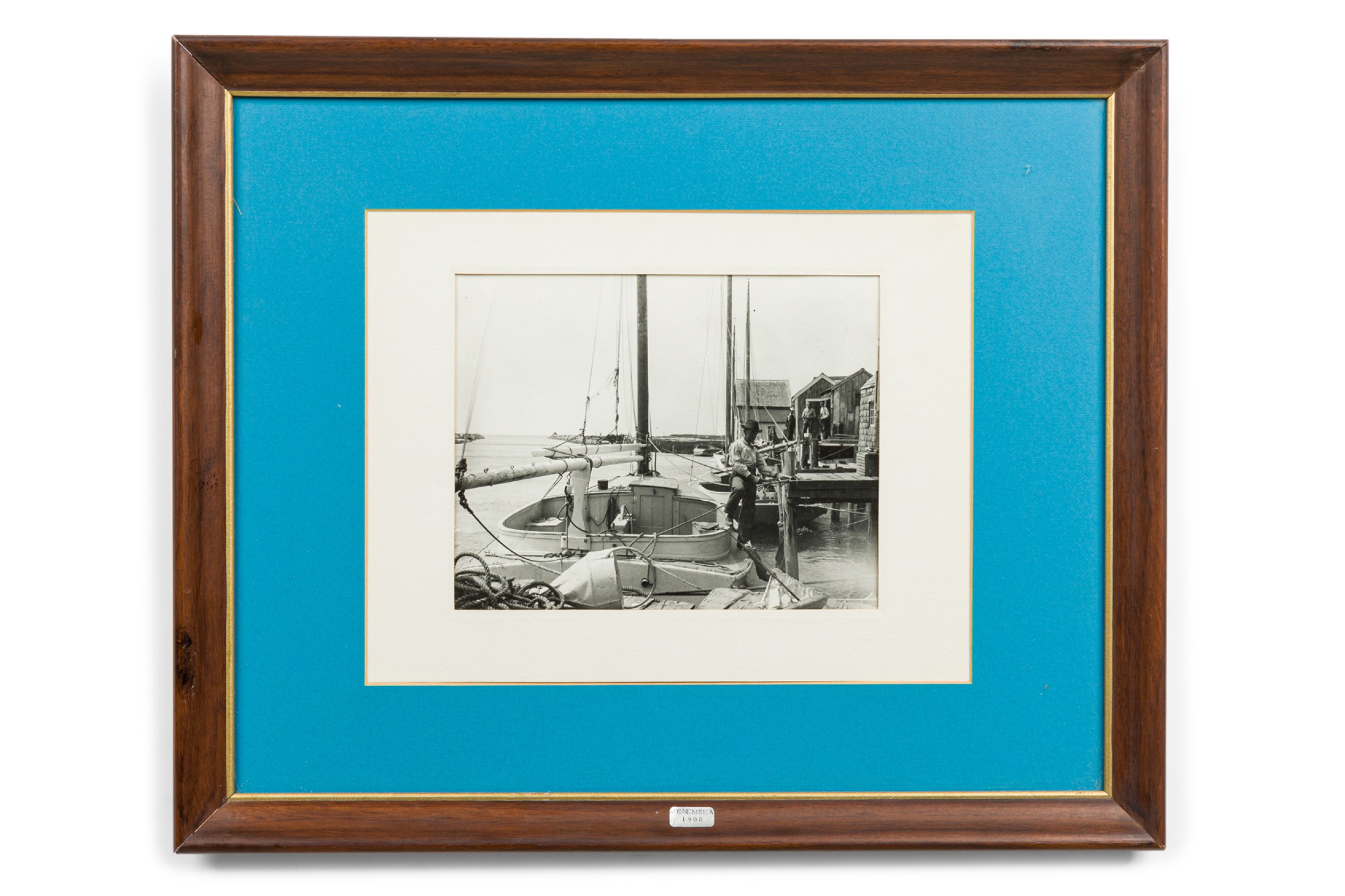 American mid century photograph of a man standing on a boat at the docks