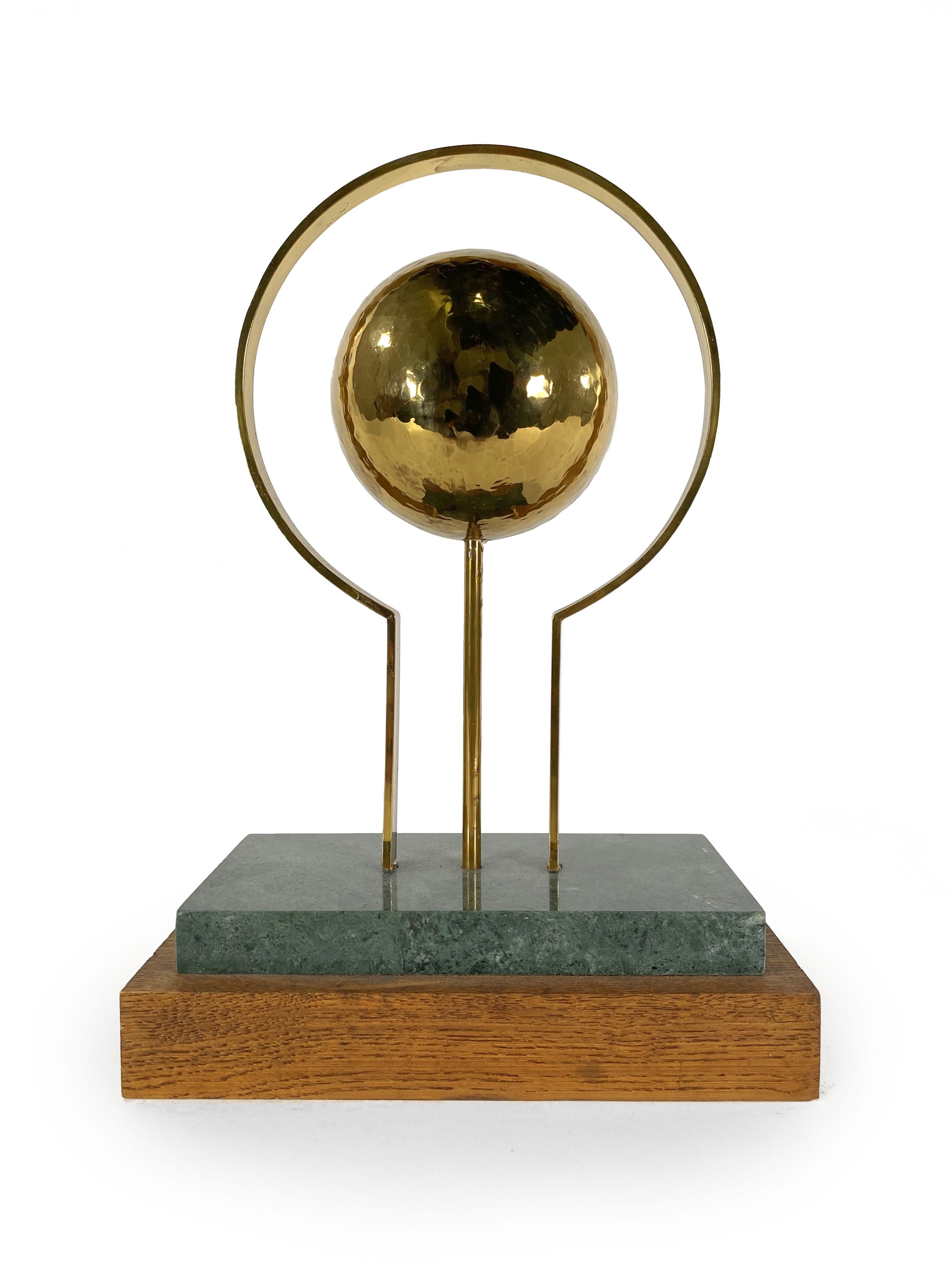 Round sculpture in brass with rectangular base