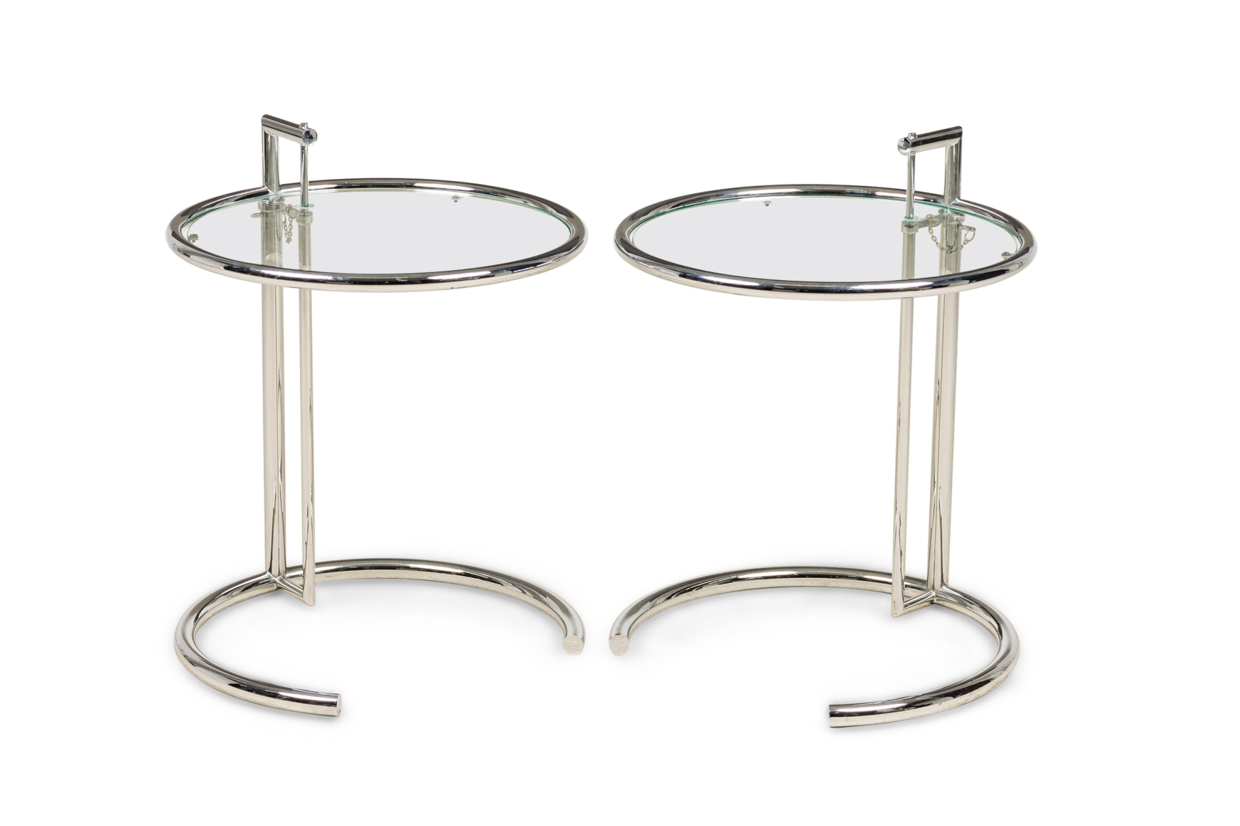 A pair of eileen gray polished chrome and glass tables