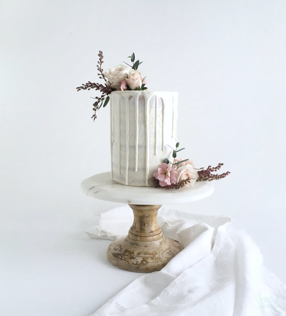 semi naked smash cake with white chocolate ganache drip