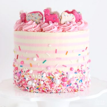 pink and white striped circus cake with sprinkles