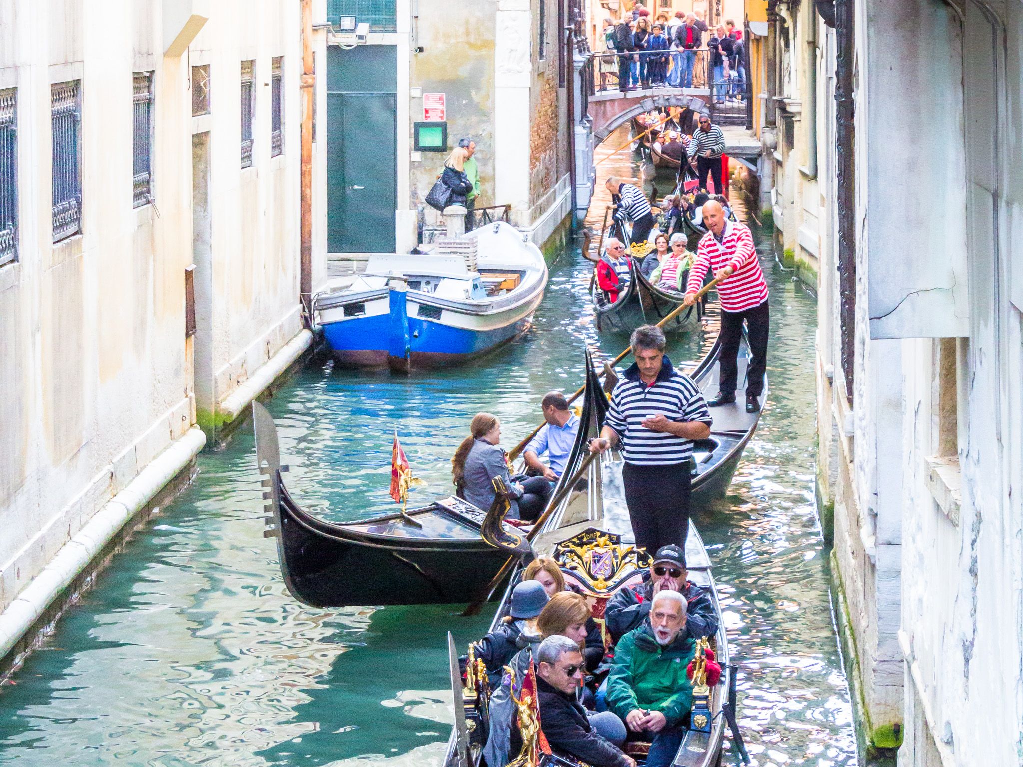 queue of Venetian gondolas below the Bridge of Sighs