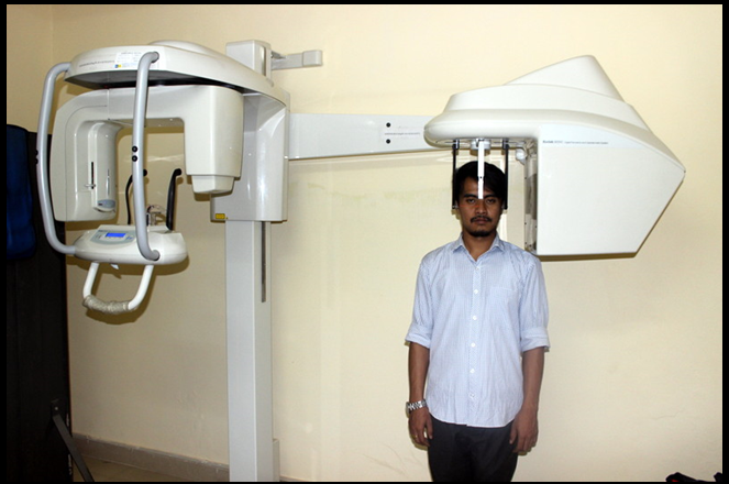 Individual positioned within the Cephalostat for lateral cephalogram in front view.