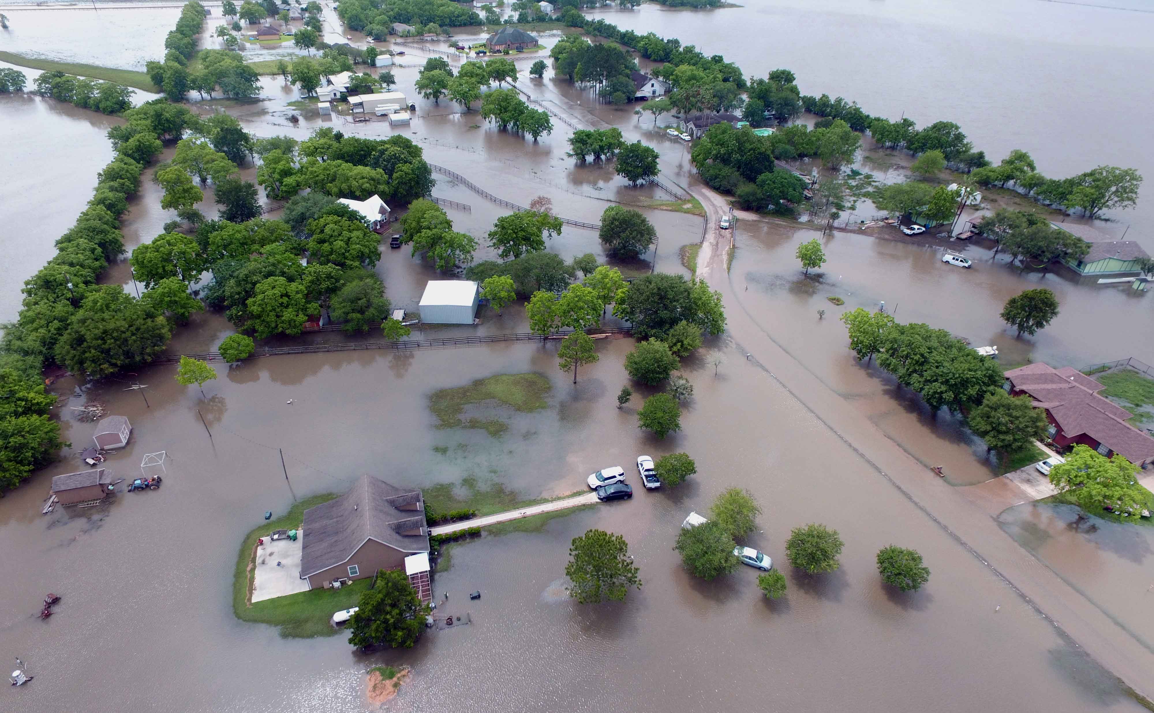 flooding in the area of galler road with homes, cars, roads, and livestock inundated