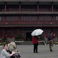 Wife and child and classic Chinese architecture.