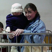 Aelex and Mommy stand by her old crib.