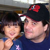 Aelex and her Daddy eat overpriced airport french fries.