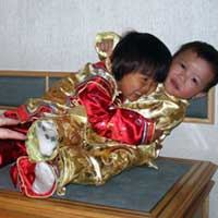 Aelex demonstrates perfect tackling form to her brother.