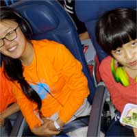 Faces just before we told them there was 14&frac14; hours left in the flight.